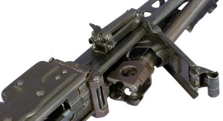 Barrel change for MG 42 - barrelis unlatched and its breech part is exposed for removal.